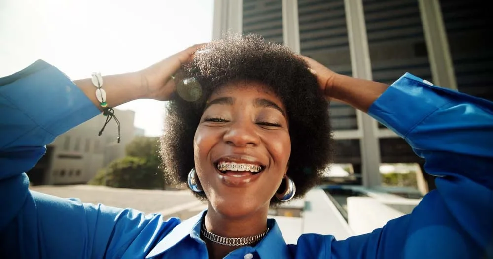 Guest smiling with braces at Smiling Out Loud Orthodontics